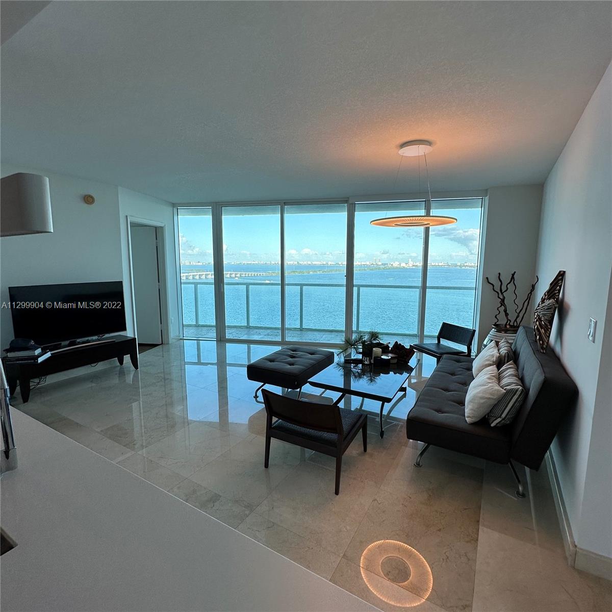 665 Northeast 25th Street, Unit 2104 Miami, FL 33137 - Photo 7 of 38 a living room with furniture and a large window