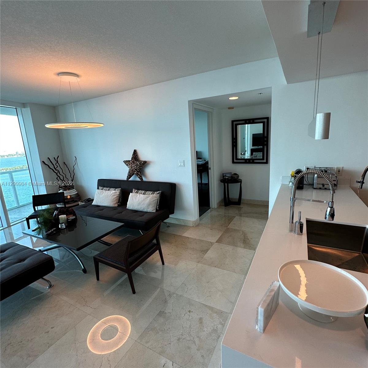 665 Northeast 25th Street, Unit 2104 Miami, FL 33137 - Photo 8 of 38 a living room with furniture and a wooden floor