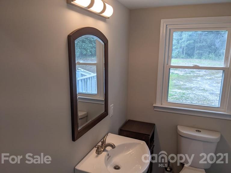 2271 West Chester School Road Chester, SC 29706 - Photo 15 of 19 a bathroom with a toilet sink and mirror