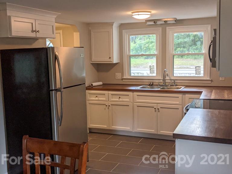 2271 West Chester School Road Chester, SC 29706 - Photo 5 of 19 a kitchen with stainless steel appliances granite countertop a refrigerator sink and cabinets