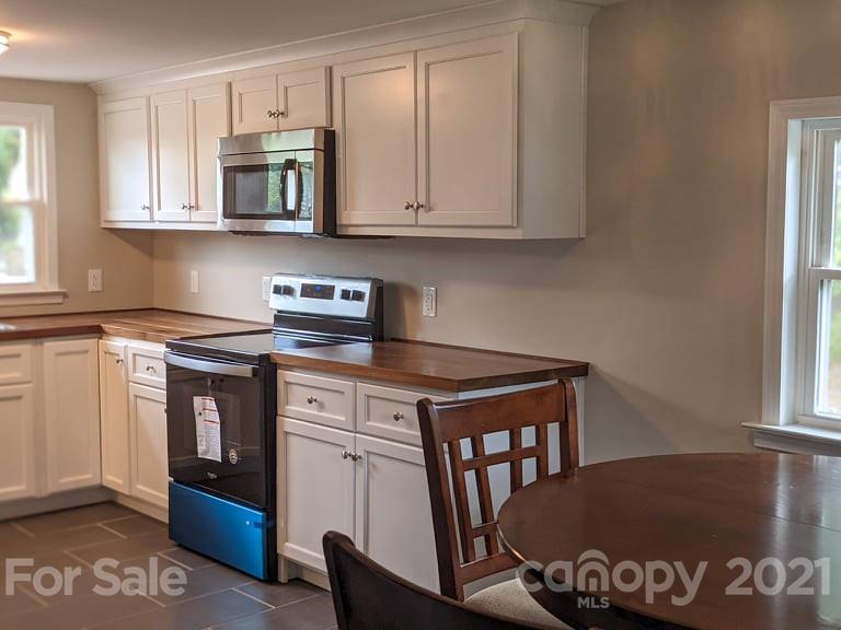2271 West Chester School Road Chester, SC 29706 - Photo 6 of 19 a kitchen with stainless steel appliances granite countertop a stove a sink and a microwave