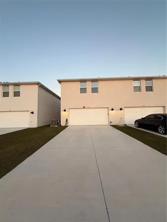 a view of a house with swimming pool and a table or chairs