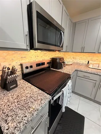 a kitchen with a stove and a microwave