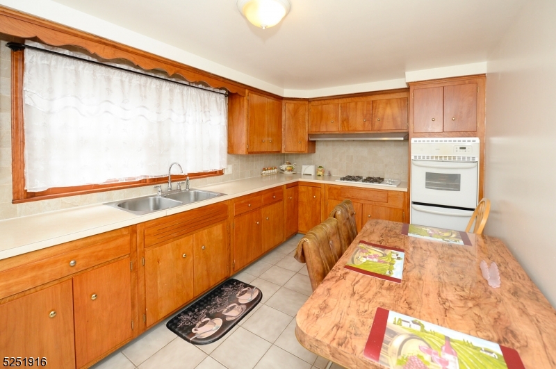4 Mary Street Hawthorne, NJ 07506 - Photo 4 of 12 a kitchen with a sink and a stove top oven