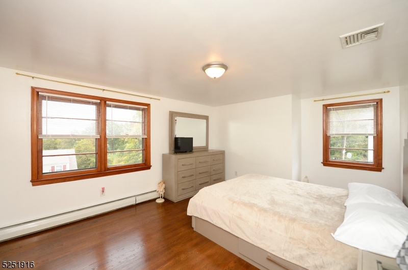 4 Mary Street Hawthorne, NJ 07506 - Photo 6 of 12 a bedroom with a bed and a large window