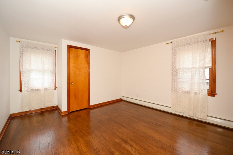 4 Mary Street Hawthorne, NJ 07506 - Photo 8 of 12 an empty room with wooden floor and windows