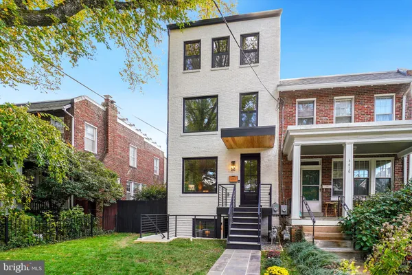 front view of a brick house with a yard