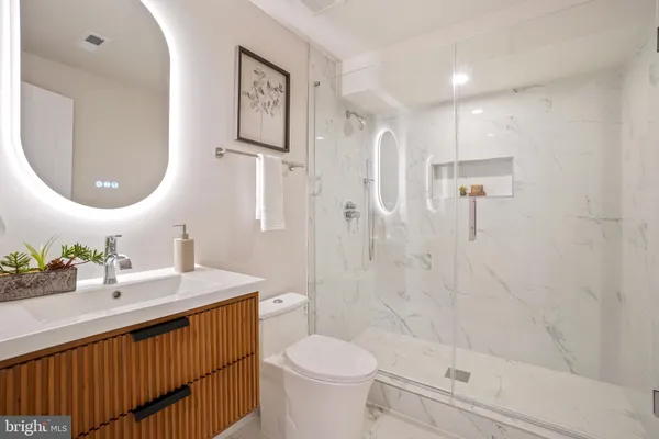 a bathroom with a sink toilet and shower