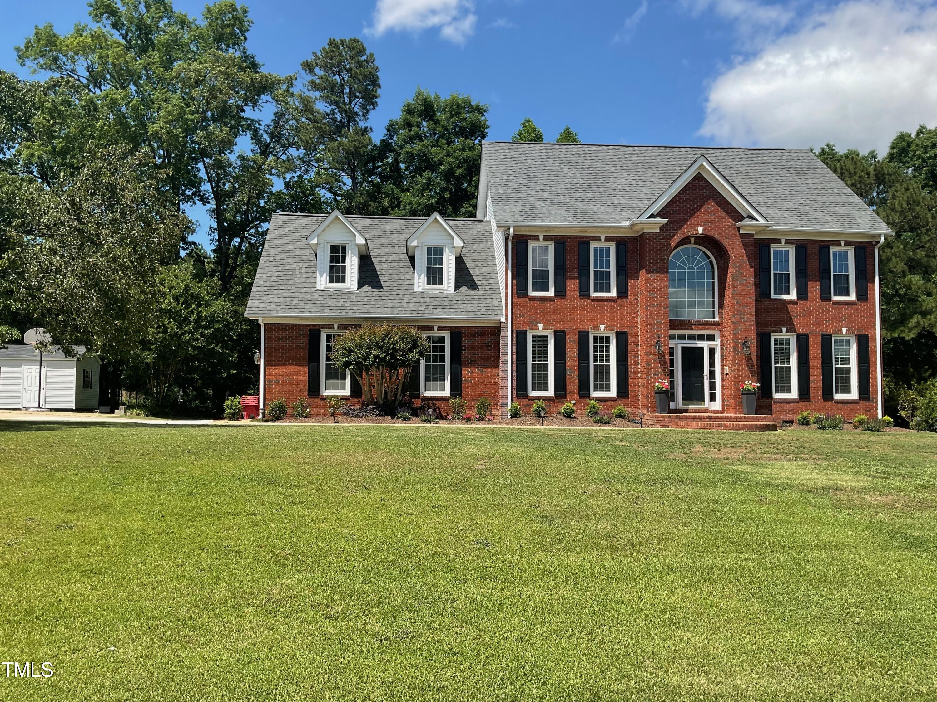 4209 Old Lewis Farm Road Raleigh, NC 27604 - Photo 1 of 47 a front view of a house with a garden