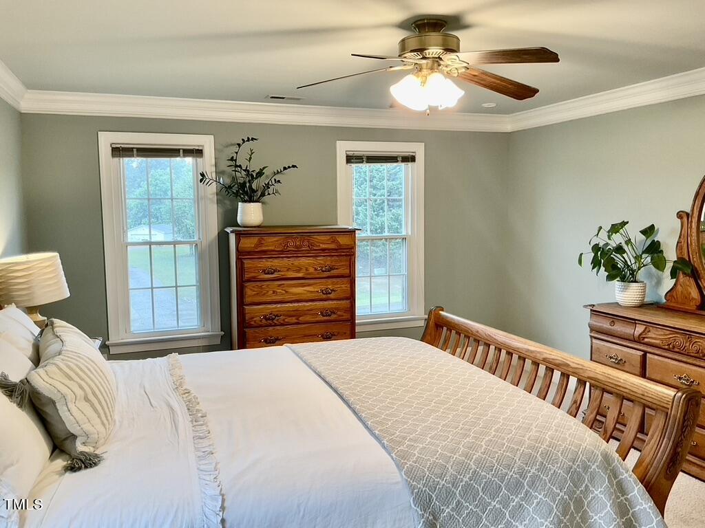 4209 Old Lewis Farm Road Raleigh, NC 27604 - Photo 14 of 47 a bedroom with a bed and a chandelier