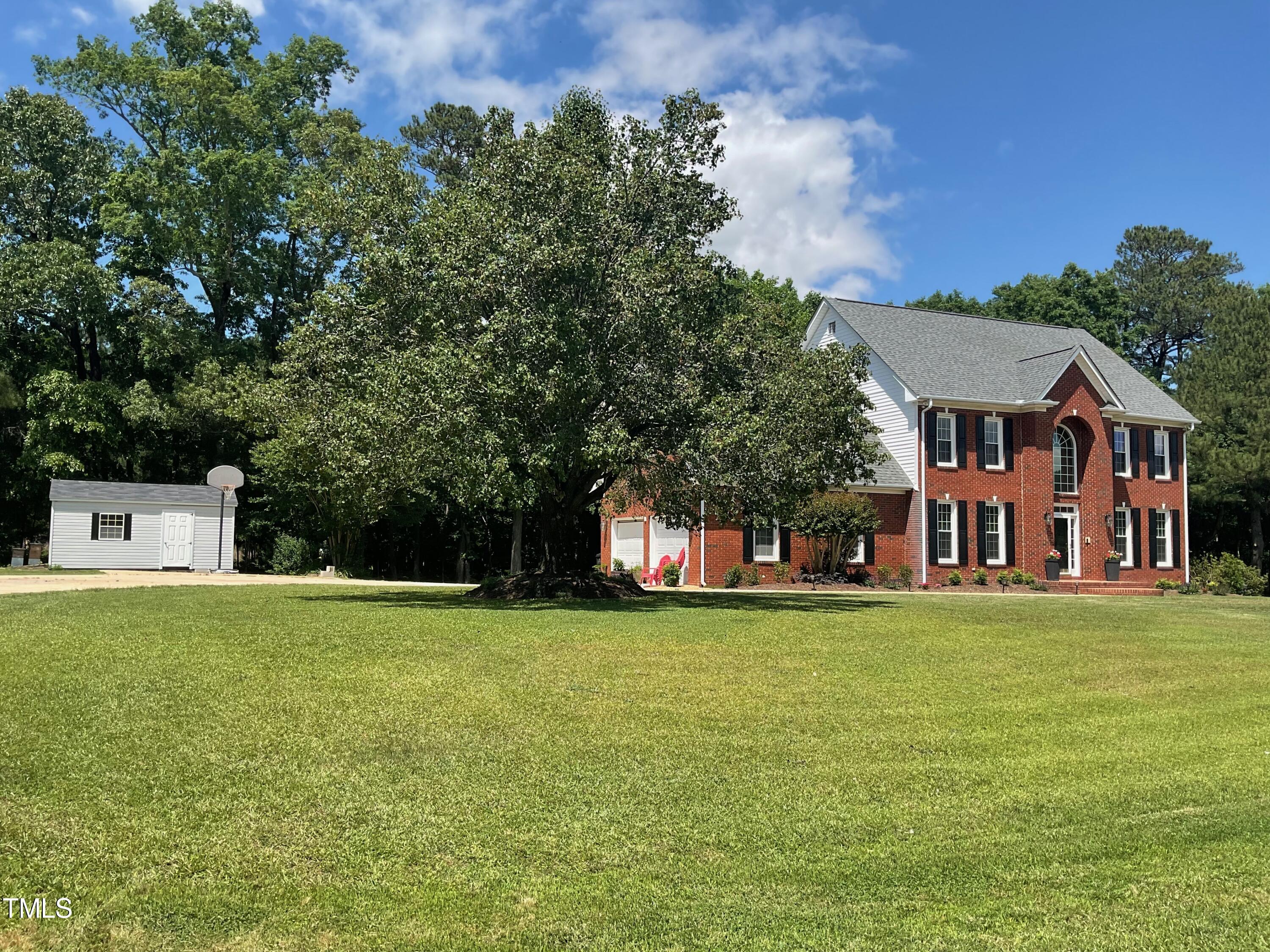 4209 Old Lewis Farm Road Raleigh, NC 27604 - Photo 2 of 47 a view of a house with a big yard and large trees