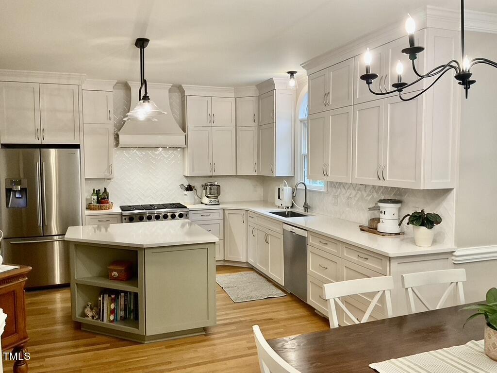 4209 Old Lewis Farm Road Raleigh, NC 27604 - Photo 3 of 47 a kitchen with a stove a refrigerator and a sink