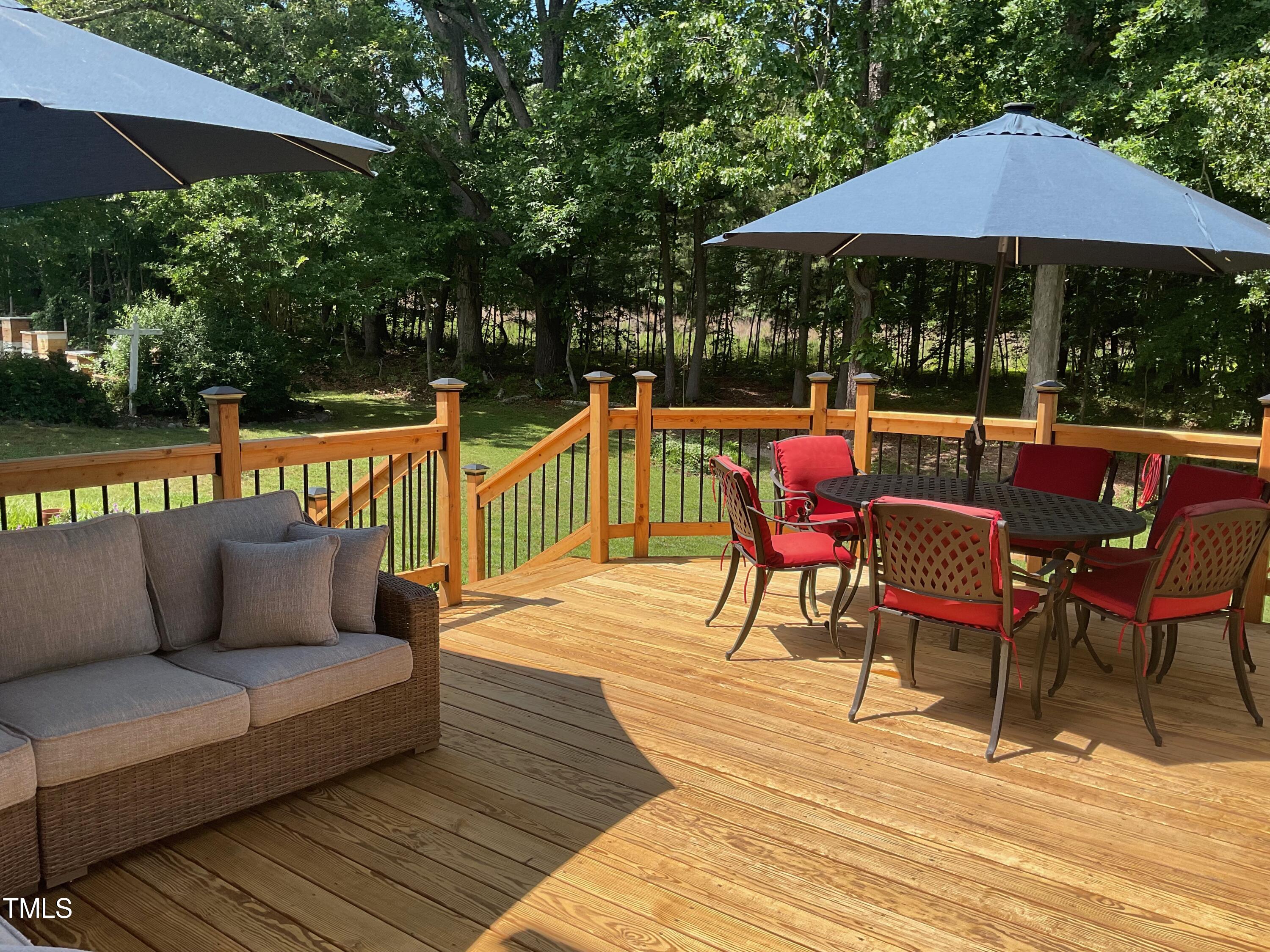 4209 Old Lewis Farm Road Raleigh, NC 27604 - Photo 35 of 47 an outdoor sitting area with furniture and umbrella