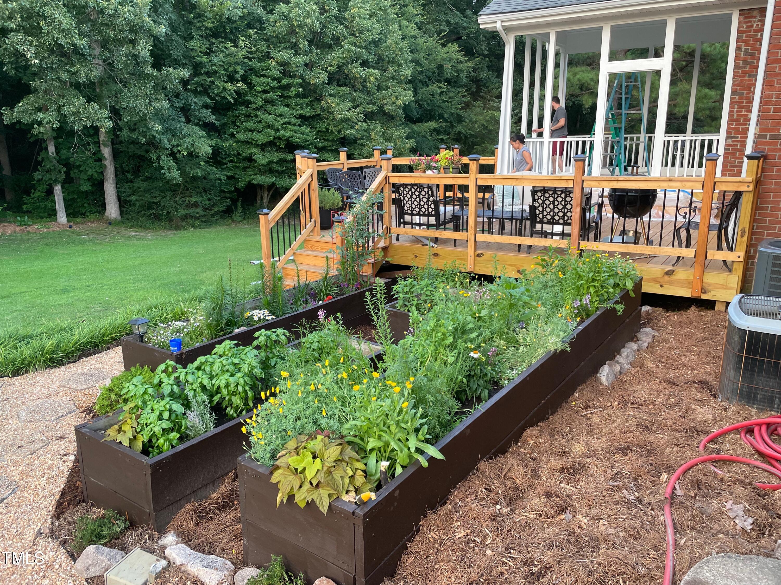 4209 Old Lewis Farm Road Raleigh, NC 27604 - Photo 39 of 47 a view of a house with backyard sitting area and garden