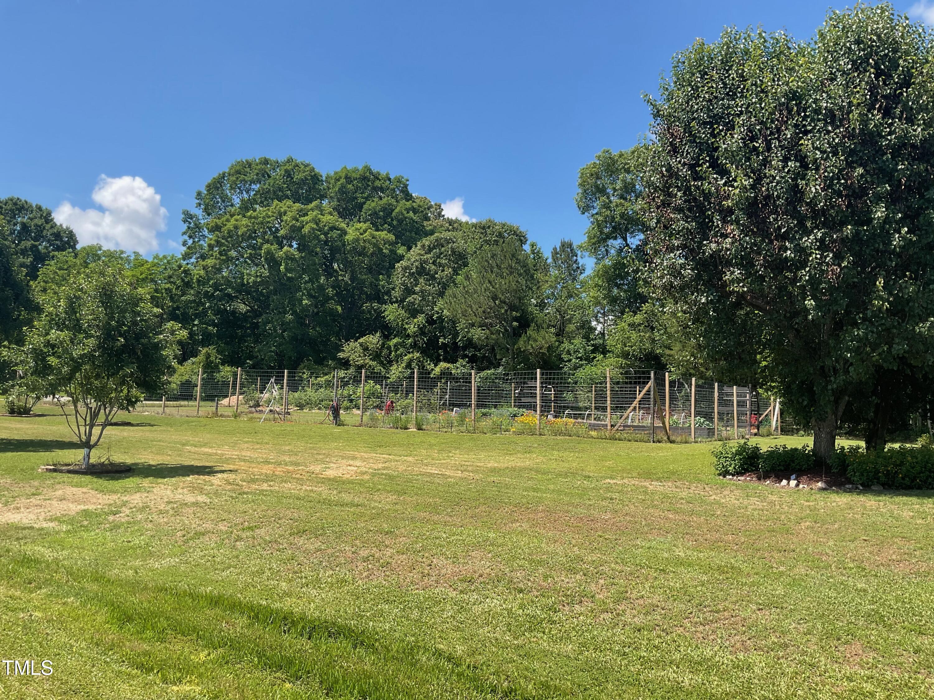 4209 Old Lewis Farm Road Raleigh, NC 27604 - Photo 40 of 47 a view of swimming pool with a yard and trees