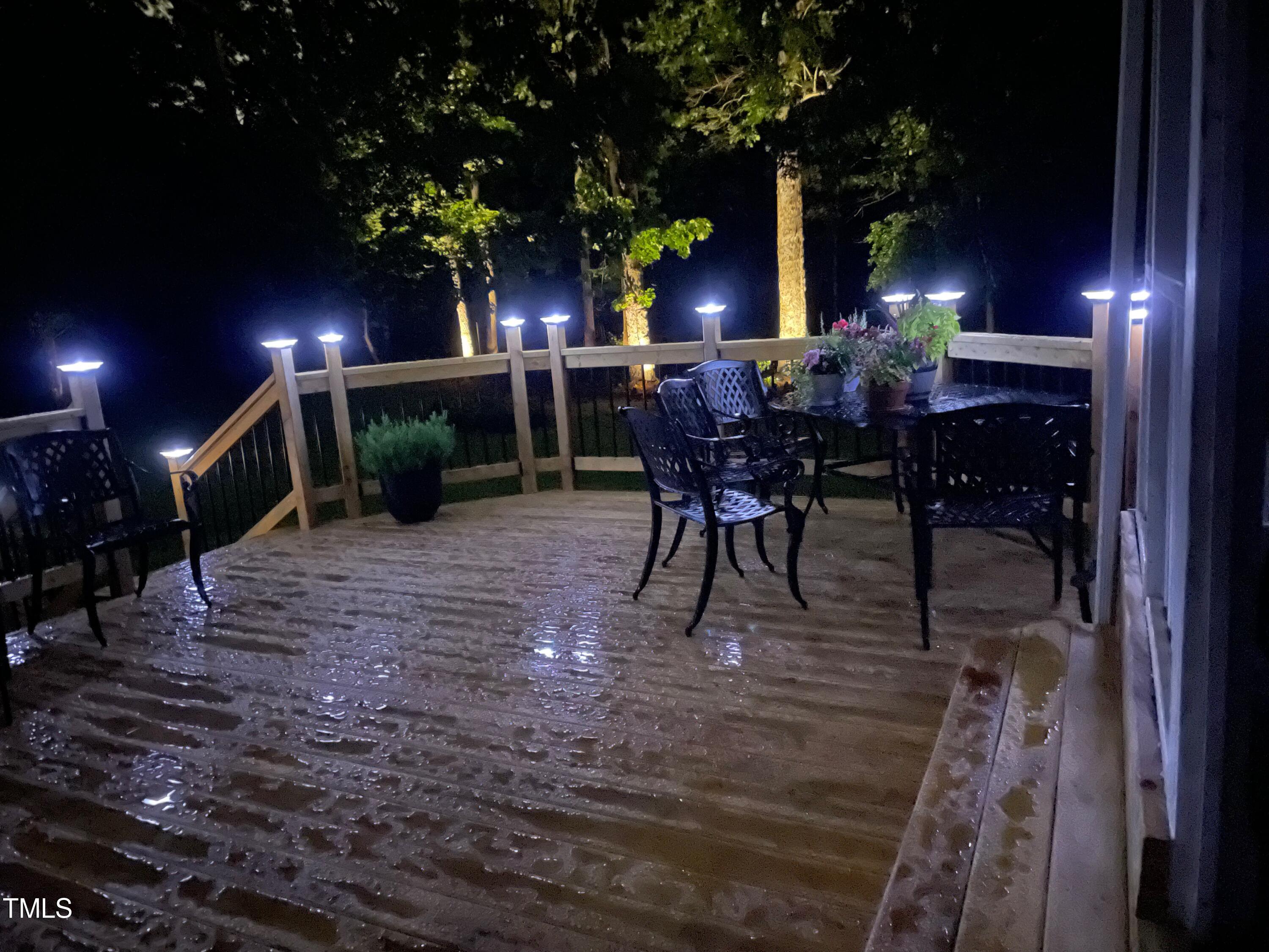 4209 Old Lewis Farm Road Raleigh, NC 27604 - Photo 45 of 47 a view of a porch with dining table and chairs with a fire pit