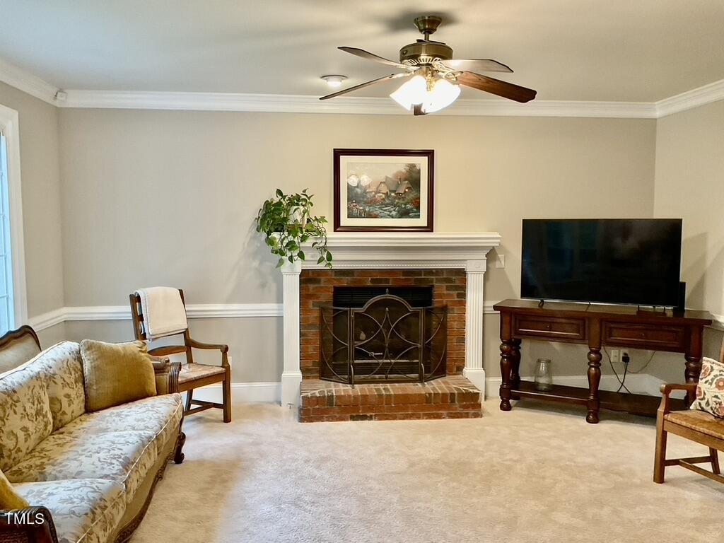 4209 Old Lewis Farm Road Raleigh, NC 27604 - Photo 8 of 47 a living room with furniture and a flat screen tv