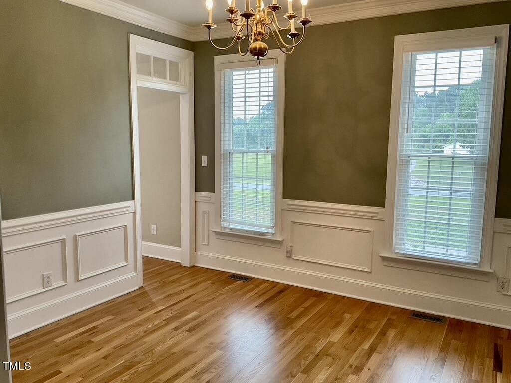 4209 Old Lewis Farm Road Raleigh, NC 27604 - Photo 10 of 47 a view of an empty room with wooden floor and a window