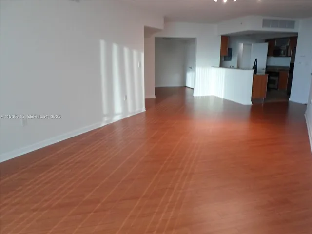 a kitchen with stainless steel appliances granite countertop a refrigerator and a stove