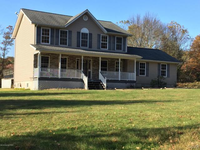 5644 Neola Road Stroudsburg, PA 18360 - Photo 1 of 24 a front view of a house with a yard table and chairs