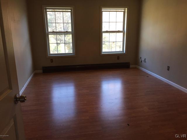 5644 Neola Road Stroudsburg, PA 18360 - Photo 16 of 24 an empty room with wooden floor and windows