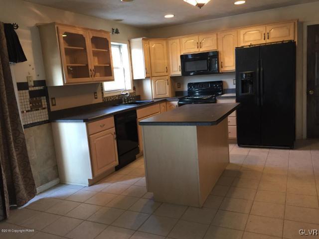 5644 Neola Road Stroudsburg, PA 18360 - Photo 5 of 24 a kitchen with stainless steel appliances a refrigerator a stove a sink and a microwave