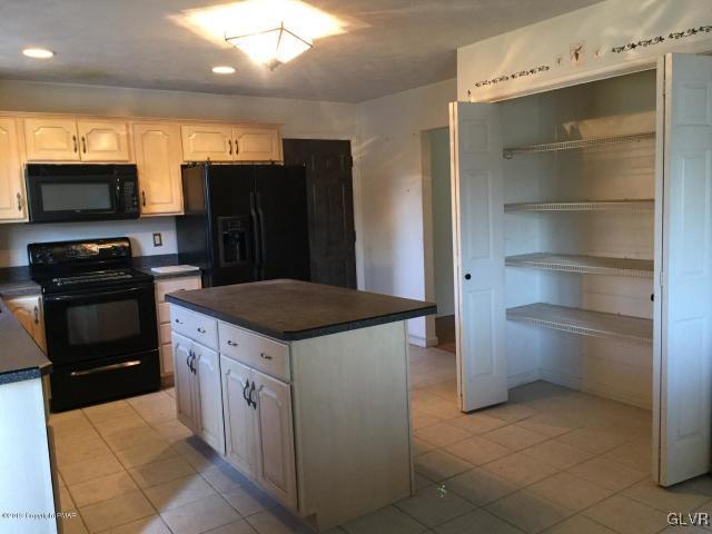 5644 Neola Road Stroudsburg, PA 18360 - Photo 6 of 24 a kitchen with a stove and a refrigerator