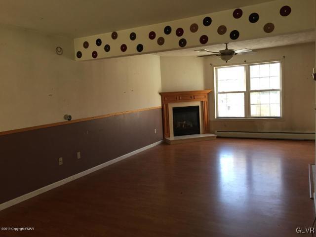 5644 Neola Road Stroudsburg, PA 18360 - Photo 7 of 24 a view of an empty room with wooden floor and a fireplace
