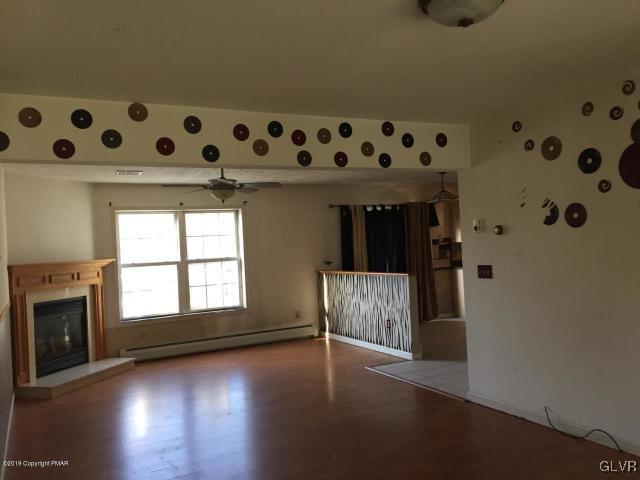 5644 Neola Road Stroudsburg, PA 18360 - Photo 8 of 24 a view of an empty room with wooden floor and a window