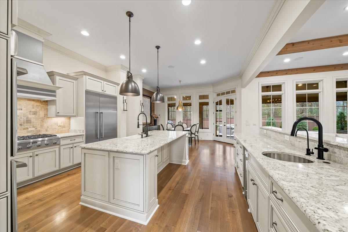 547 Lambs Brook Lane Collierville, TN 38017 - Photo 14 of 40 a large kitchen with stainless steel appliances granite countertop a lot of counter space and wooden floors