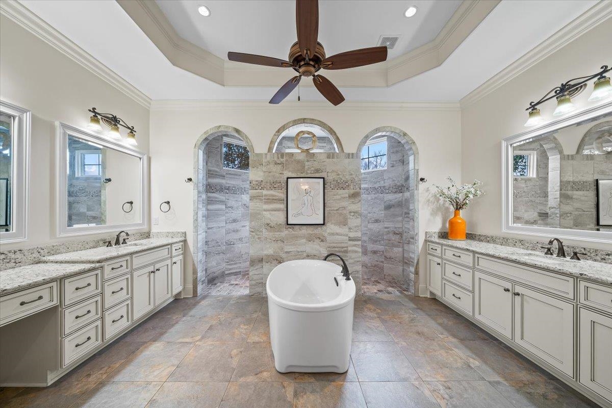 547 Lambs Brook Lane Collierville, TN 38017 - Photo 21 of 40 a bathroom with a double vanity sink a mirror a toilet and a shower