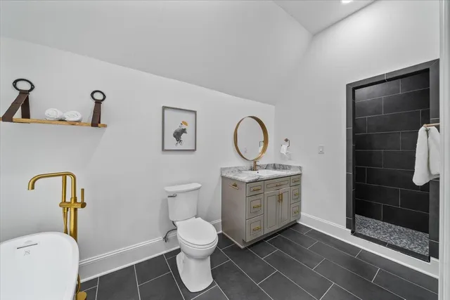 a bathroom with a toilet sink and shower