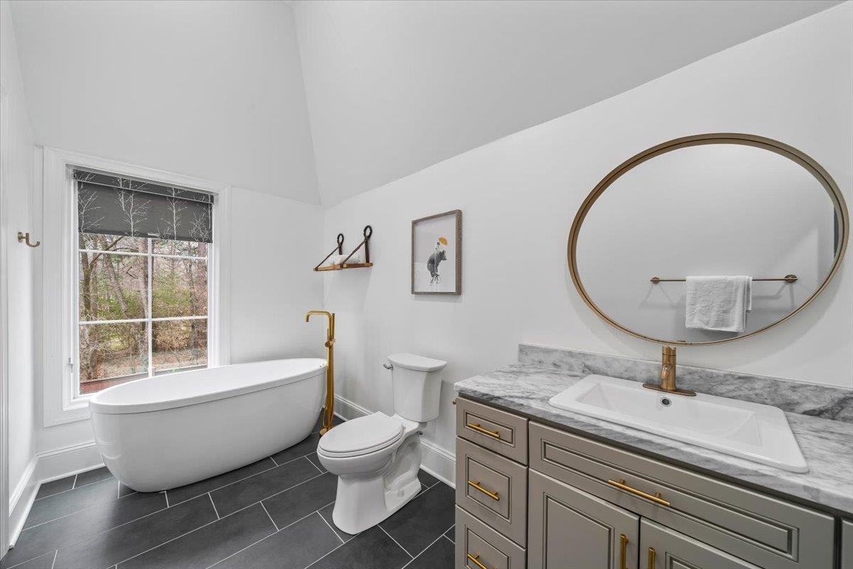 547 Lambs Brook Lane Collierville, TN 38017 - Photo 31 of 40 a spacious bathroom with a toilet sink and mirror