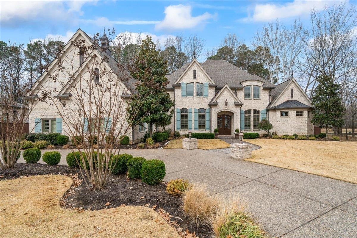 547 Lambs Brook Lane Collierville, TN 38017 - Photo 4 of 40 a view of a white house with a yard and pathway