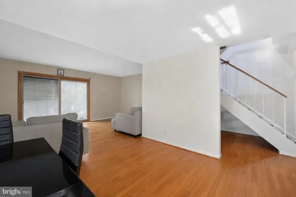 a living room with wooden floor and furniture