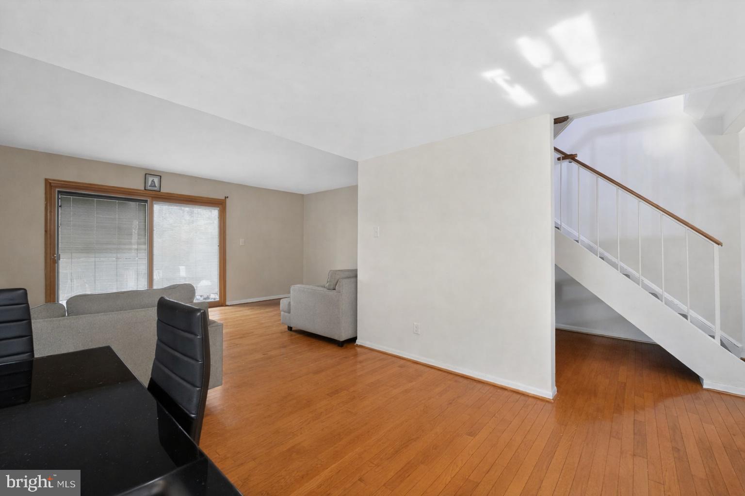 9214 Three Oaks Drive Silver Spring, MD 20901 - Photo 7 of 14 a living room with wooden floor and furniture