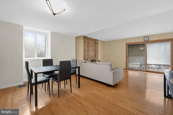a living room with furniture wooden floor and a table