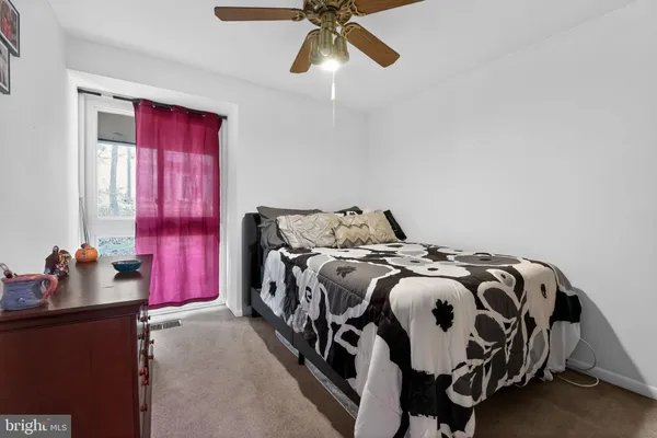 a bedroom with bed and a window