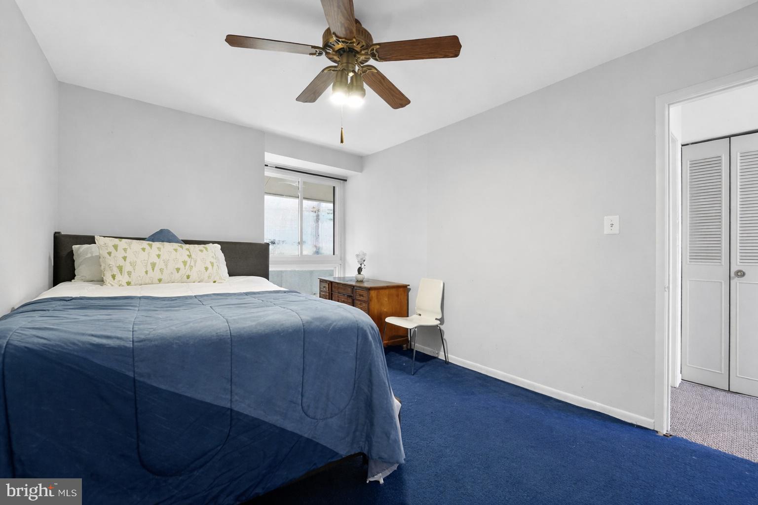 9214 Three Oaks Drive Silver Spring, MD 20901 - Photo 10 of 14 a bedroom with a bed and a chandelier