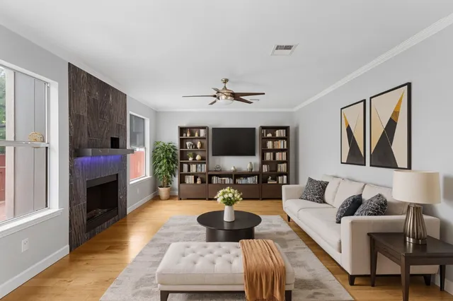 a living room with furniture fireplace and a flat screen tv