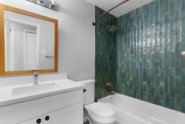 an empty room with closet and a ceiling fan