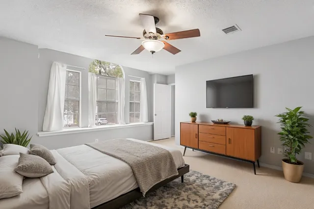 a bedroom with a bed and a flat screen tv