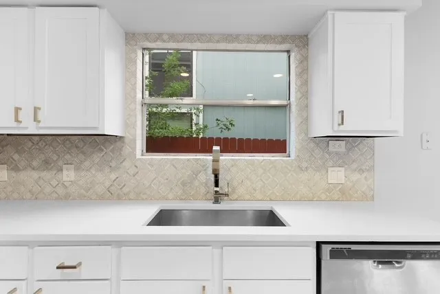 a kitchen with a sink and cabinets