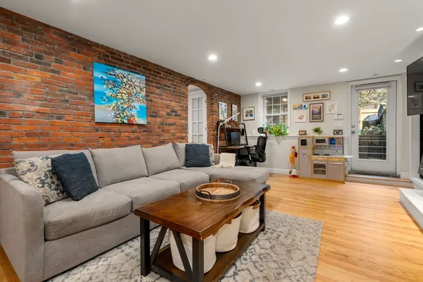 a living room with furniture and wooden floor