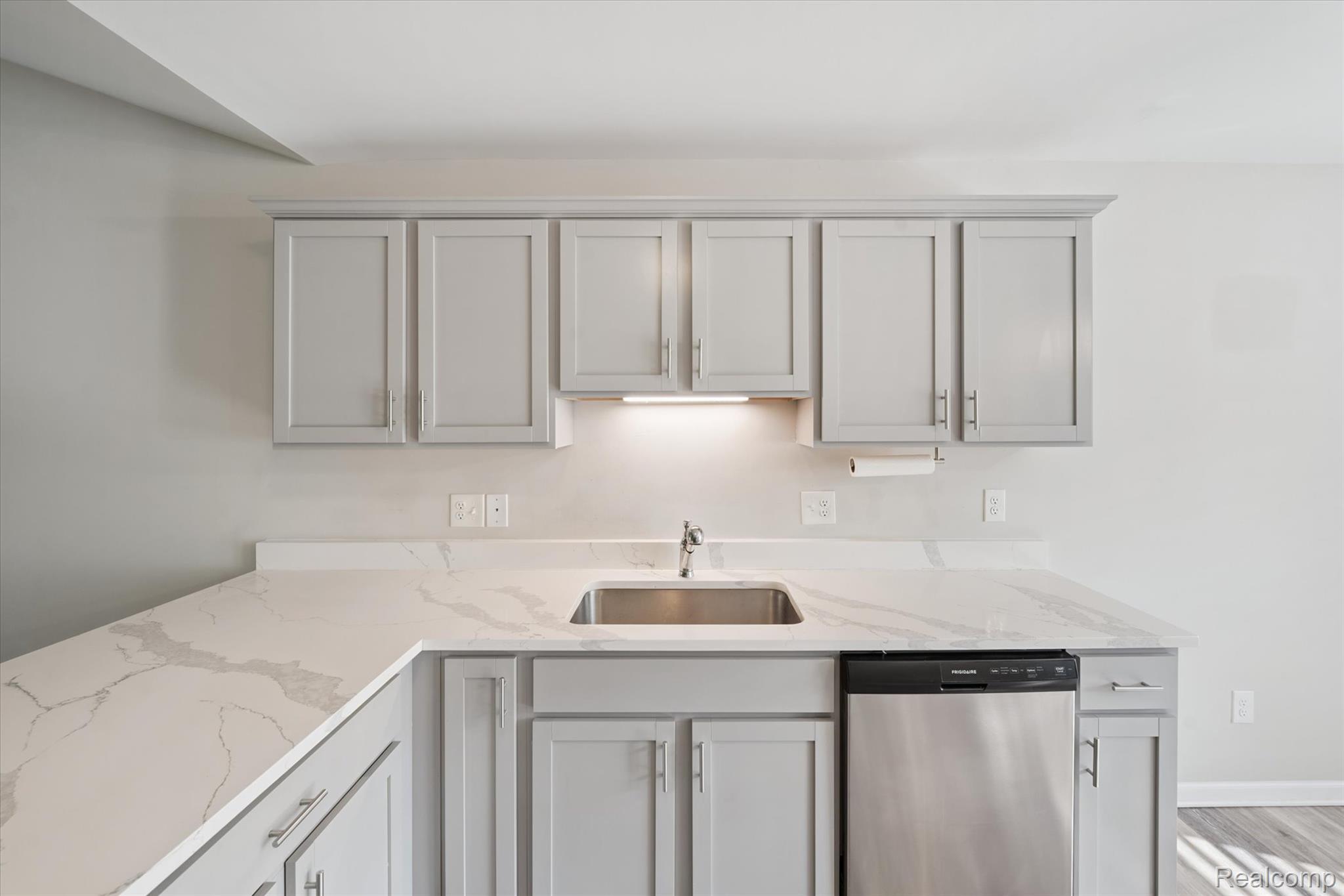 816 Nelson's Ridge Drive Howell, MI 48843 - Photo 8 of 36 Quartz countertops, under-cabinet lighting, and stainless steel sink create a stylish workspace.