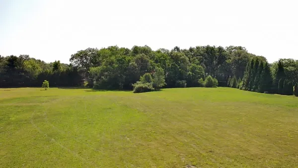 a swimming pool is in the middle of a field