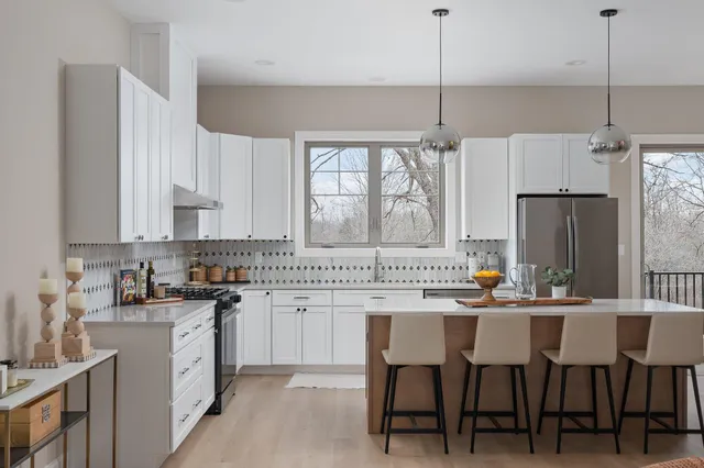 a kitchen that has a lot of cabinets a sink and a stove in it