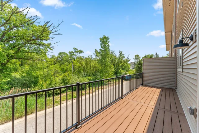 a view of balcony with wooden floor and fence