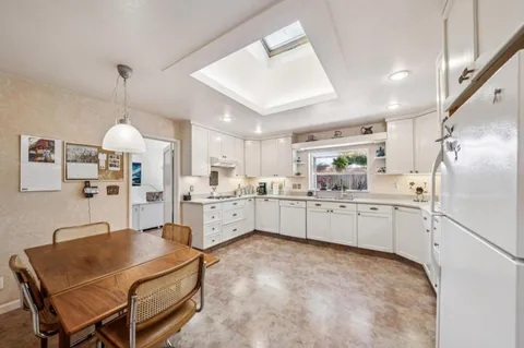 a kitchen with furniture a counter top space stainless steel appliances and cabinets