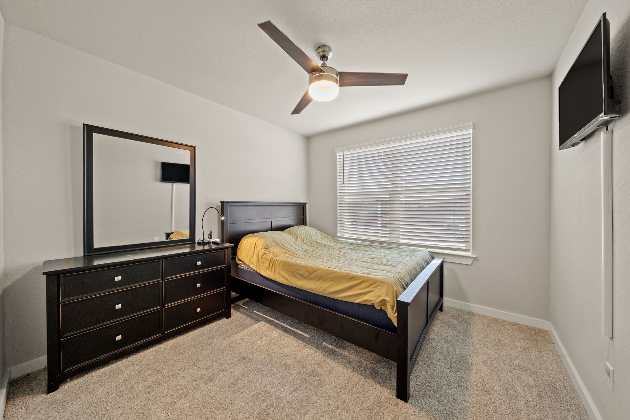 1117 Tipton Street Georgetown, TX 78633 - Photo 26 of 40 Room featuring light neutral wall paint, a ceiling fan with integrated lighting, and a single window with horizontal blinds